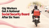 A delivery rider on a motorcycle with a red insulated bag, as India notifies a National Social Security Board for gig and platform workers