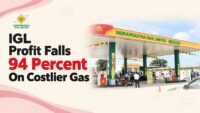 IGL CNG station in Delhi-NCR with the Indraprastha Gas Limited wordmark and a headline showing quarterly profit fell 94 percent