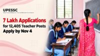 Girl students writing in notebooks while a teacher teaches at a blackboard in an Uttar Pradesh government school